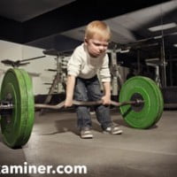 photo of boy struggling to lift heavy barbell or weight on hrexaminer
