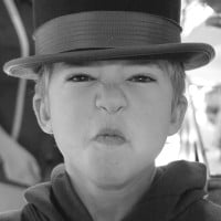 black and white photo of young boy scrunching up his face