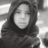 black and white photo of little boy in a hooded sweatshirt