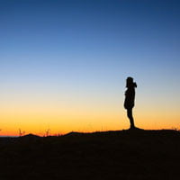 photo of woman looking out over mountain range in post by Heather Bussing on HRExaminer.com called Eggs of Happiness
