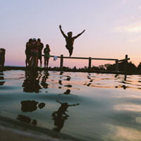 photo of man jumping in pool representing the concept of human in the feature article for HR Examiner v6.02 for January 16, 2015
