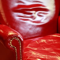 photo of red leather chair on hrexaminer.com article February 17, 2015 from Heather Bussing on sexual harrassment