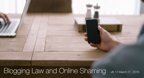 photo of person holding or looking at iphone with hand resting on table in feature photo for HRExaminer.com v6.12 for March 27, 2015