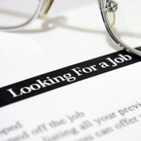 photo of resume with text 'looking for a job' and glasses in background on hrexaminer.com article April 2, 2015 by John Sumser