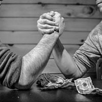 photo of arm wrestling for money in HRExaminer.com feature article v6.31 for August 14, 2015