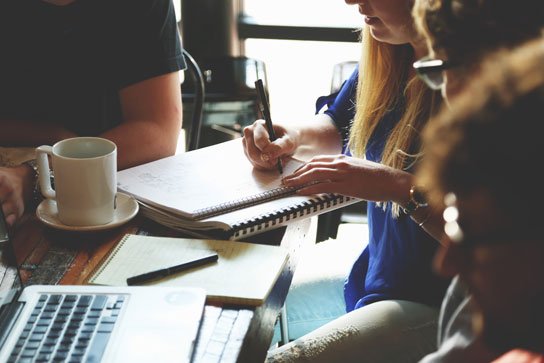 photo of people working together in a coffee shop in HRExaminer.com article by John Sumser published 2015-09-09 