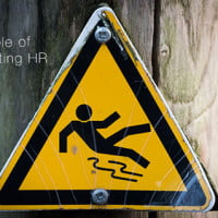 photo of warning sign "slippery when wet" on HRExaminer.com feature image v7.09 The gamble of implementing HR software